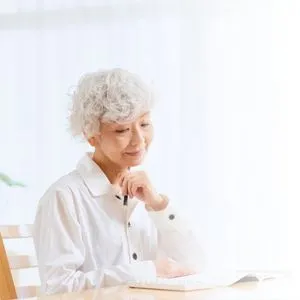 An older woman sitting comfortably at home