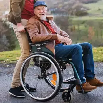 An older man enjoying the outdoors in a wheelchair